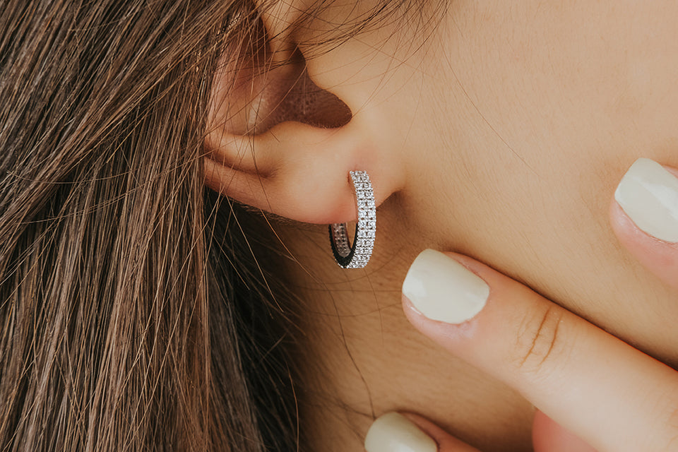 close up of a small diamond hoop earring