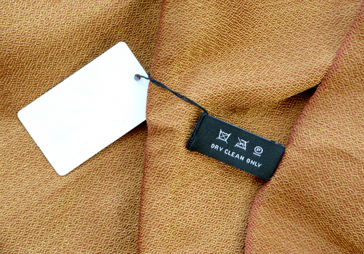 a dry clean only label on a piece of textured silk
