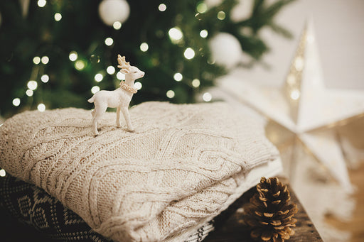 cozy knitted sweaters next to festive decorations
