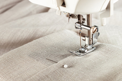 fabric being stitched on a sewing machine