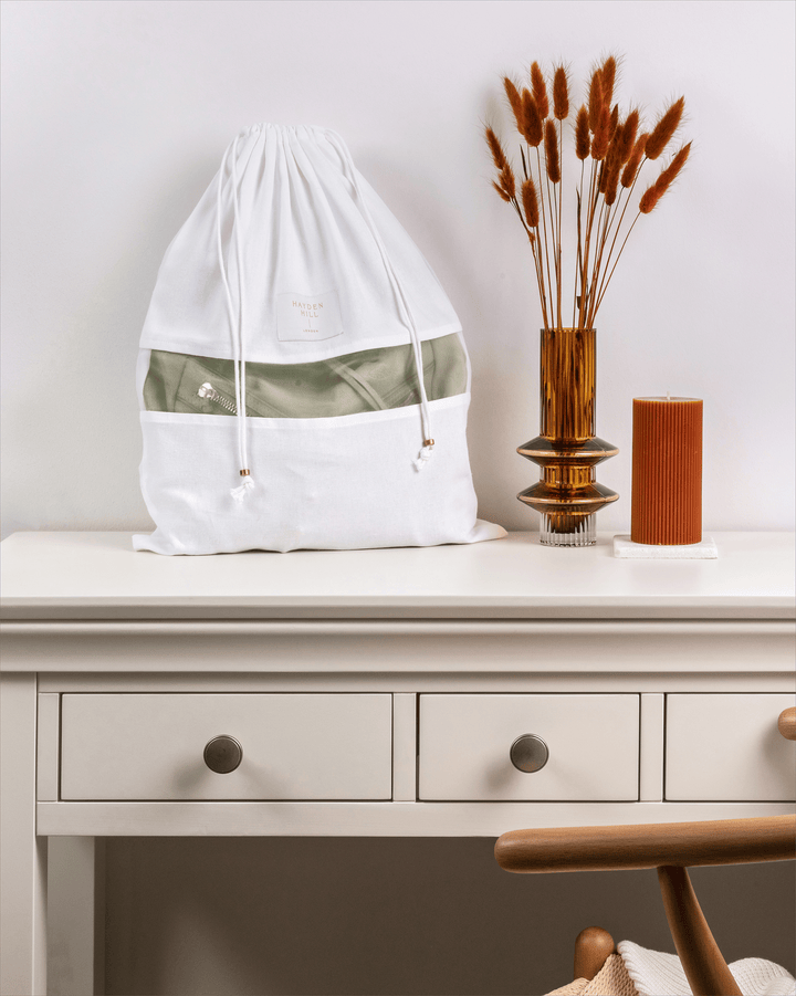 a front view of a medium dust bag on a dressing table