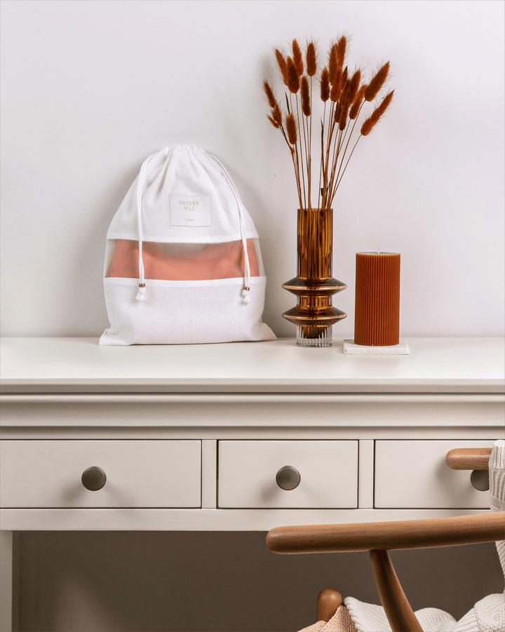 a front view of a small dust bag on a dressing table