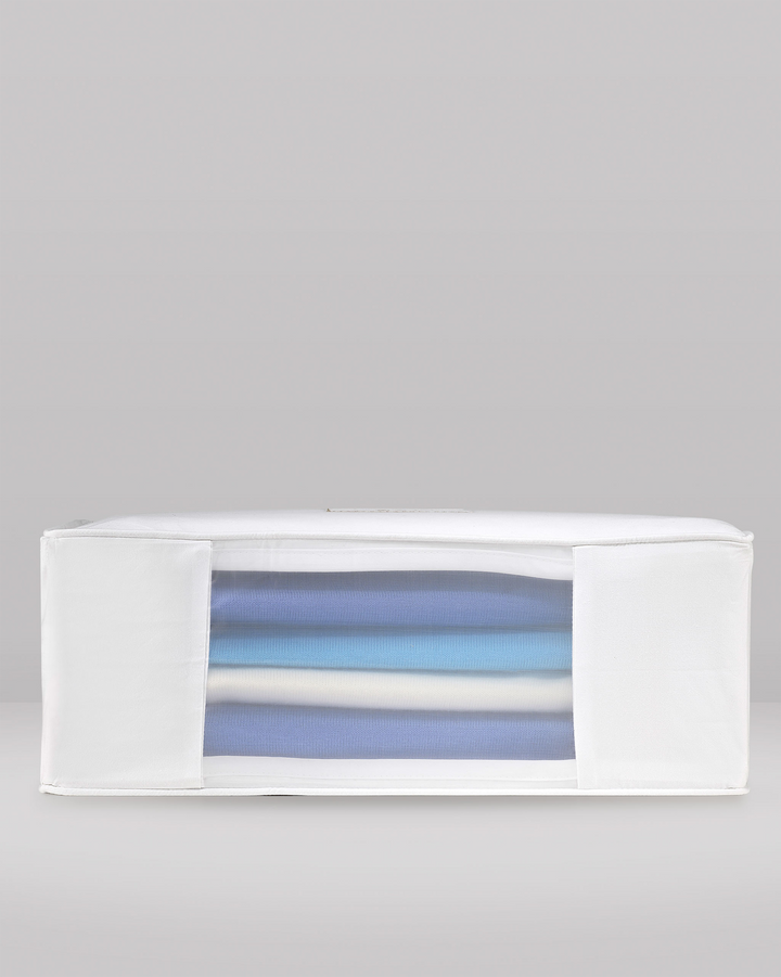 the side profile of a large clothes storage bag showing the organza panel and woollens stored inside