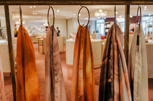 luxury silk scarves on display in a store