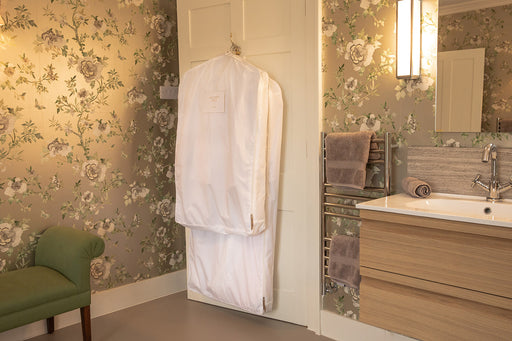 short and long Hayden Hill 100% organic cotton garment storage bags hanging on a bathroom door