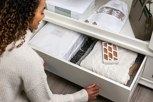  woman opening her clothes drawer displaying a Hayden Hill Moth Trap placed inside