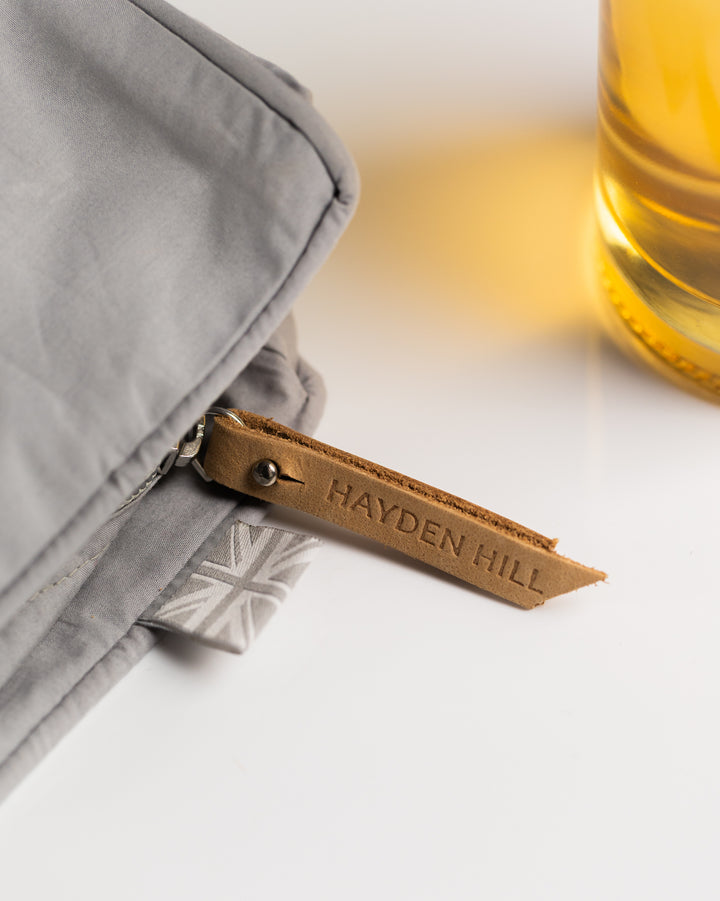 the leather zip pull and Union Jack pip on the side of a storage bag