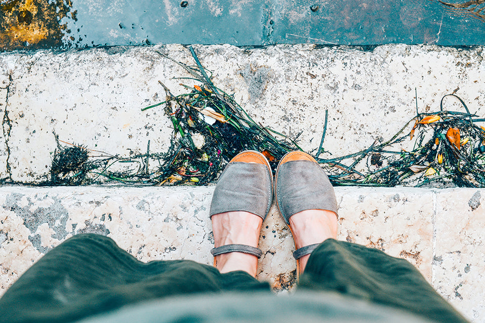 standing on steps looking down on  gray\green sandals