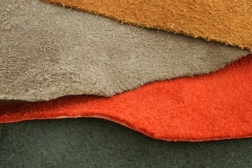 suede in green, rust, beige and ochre colors