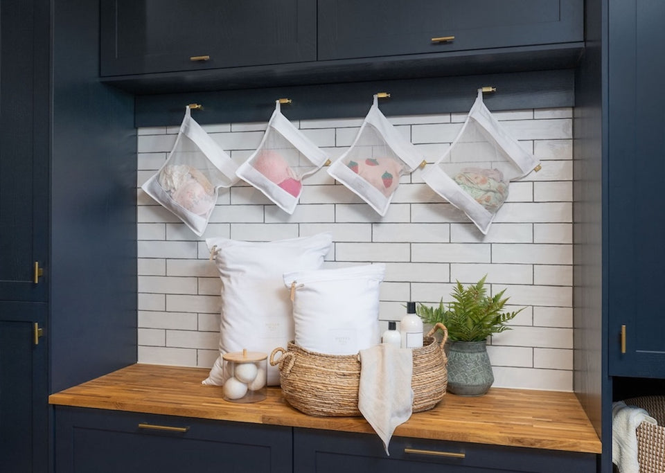 a collection of white mesh organic cotton laundry bags and white travel laundry bags