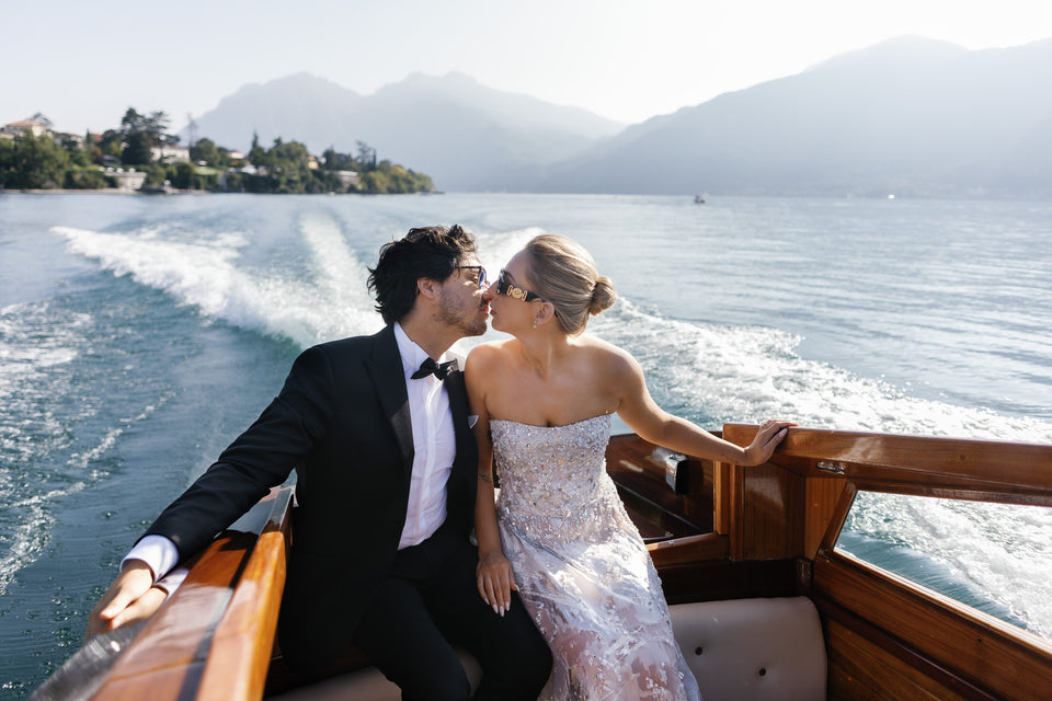 a glamorous couple enjoying a speedboat ride while celebrating their marriage on Lake Como in Italy