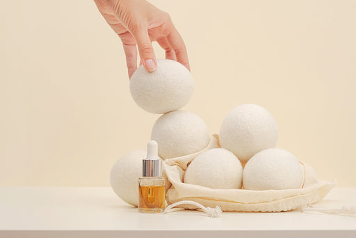wool dryer balls and bottle of essential oil